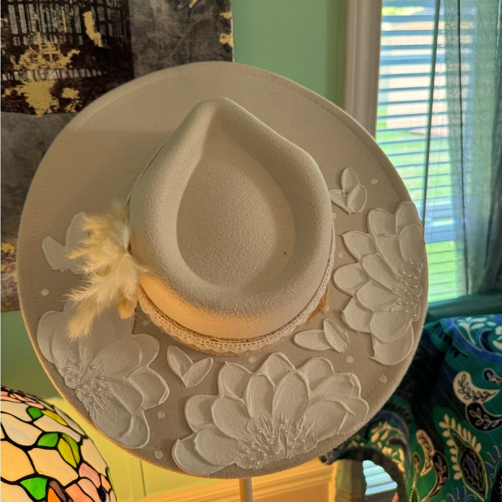 Hand painted Cowboy hat. It is Cream color with hand painted white flowers.
